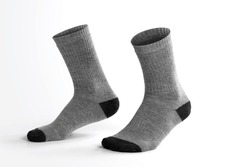 Gray socks with isolated leg shape on white background