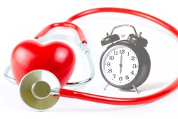 Red Stethoscope,shape Heart and clock Isolated On White Background.Blood pressure control-Health care concept