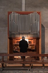 A man plays the organ in a church