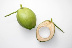 Fresh young coconuts on a white background, creative flat lay healthy food concept, top view with clipping path