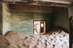 desert sand has invaded and taken over these rooms in Kolmanskoppe, Namibia