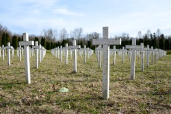 Military cemetery with white crosses. Headstones in War memorial. Numerous soldier's graves marked with Christian crosses. The fallen soldier.