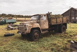 Old Soviet trucks rotting in the village