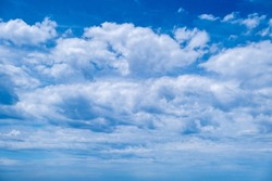 Blue sky and clouds, daylight natural background. Fluffy cumulus cloud, Cloudscape white and grey color.Fluffy cumulus clouds on blue sky background. Cloudscape white and grey color