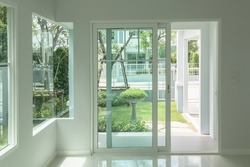 Interior atmosphere minimal style design of empty room show white wall with sliding door and glass windows looking through the outdoor garden.