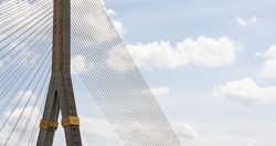 Panorama view of suspension bridge structure and cables detail.