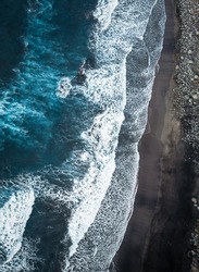 Aerial view of a beautiful volcanic black sand beach with ocean waves. Benijo Beach, Tenerife