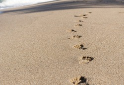 Footprints on the sandy beach, sea waves, nature background
