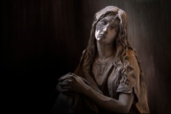 Statue, sculpture. Portrait, close-up of a woman taken in a monumental cemetery.
