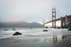 Golden Gate bridge during a misty golden hour