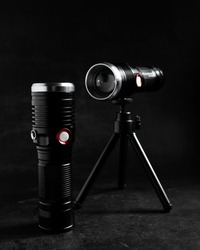 Two portable lights for photographers, a device for illuminating objects and people, on a dark background