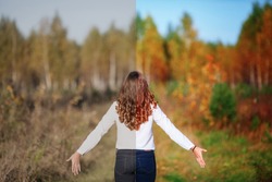 Photo before and after the image editing process. Young beautiful woman with long hair, back view. Autumn park