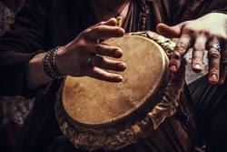 ethnic percussion musical instrument jembe and male hands