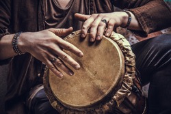 Ethnic percussion musical instrument jembe and male hands