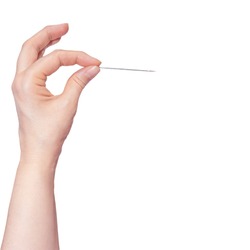 Woman's hand holding a needle on white background.