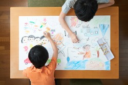 Japanese elementary school students painting in the living room