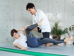 A woman receiving guidance for abdominal muscle training