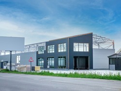construction of an industrial building with a metal frame and sandwich panels