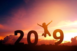 Newyear 2019 concept Silhouette young woman jumping to 2019 new year