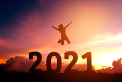 2021 Newyear Silhouette young woman jumping to Happy new year concept.