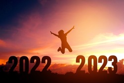 2023 Newyear Silhouette young woman jumping to Happy new year concept.