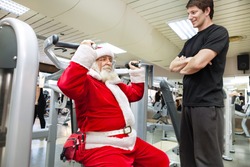 Santa Claus  exercise with personal trainer in the gym