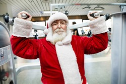 Santa Claus  doing exercise on machine at gym