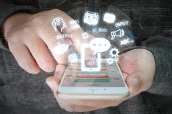 Chat bot and future marketing concept , chatbot connect icons with hand holding mobile phone and icons popup out smartphone screen.