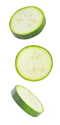 Zucchini, sliced round pieces, falling, hanging, flying, soaring, isolated on white background with clipping path.