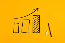 Statistical hand drawn financial graph predicting an economic financial growth or improvement on yellow background.