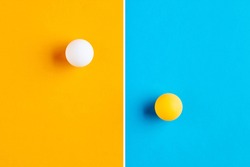 Table tennis balls in contrast. Competition, diversity, opposition or confrontation concept.