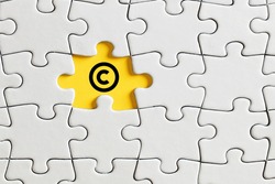 Copyright icon on missing puzzle piece. Property and intellectual rights protection.