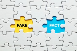 Missing puzzle pieces with the words fake versus fact. Discovering or exposing facts against fake information concept.