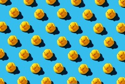 Yellow rubber duck toys pattern on seamless blue background. Bright conceptual banner design.