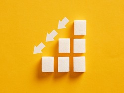 Ascending sugar cube graph with descending arrows indicating to reduce sugar intake and healthy nutrition.