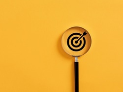 Magnifier focuses on the target icon. Focusing, finding or analyzing business goals and targets concept.