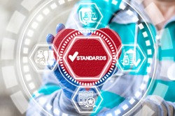 Standards Quality Medicine concept. Doctor holding red heart and standards check mark icon on virtual interface. Healthcare Control Regulation.