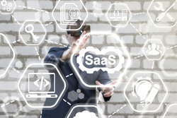 SAAS (Software As A Service) Business 3D Development Concept. Man in vr glasses offers icon cogwheels SaaS on virtual screen on background of network agility developing icons. Flexible develop support