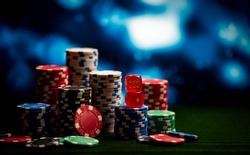 Casino. Game chips and dice lie on the table against a blurred dramatic background. Game chips for betting in gambling. Dice. Poker chips.
