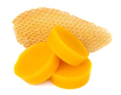 Pieces of natural beeswax and a piece of honey cell are isolated on a white background. Beekeeping products. Apitherapy.