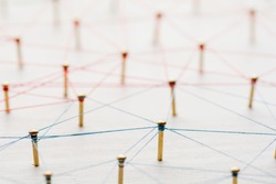 Linking entities. Network, networking, social media, internet communication abstract. A small network connected to a larger network. Web of gold wires on white wooden background. Network hub or key