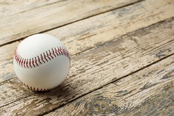 Baseball ball on old rustic wooden backstage.