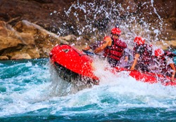 Young person rafting on the river Ganges in Rishikesh, extreme and fun sport at tourist attraction