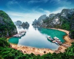 Tourist junks floating among limestone rocks at Ha Long Bay, South China Sea, Vietnam, Southeast Asia
