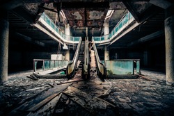 Dramatic view of damaged escalators in abandoned building. Apocalyptic and evil concept