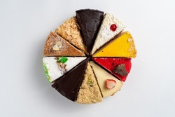 Top view of different slices of various cakes, making a single whole torte, top view on white background