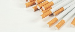 image of several commercially made cigarettes. pile cigarette on wooden. or Non smoking campaign concept, tobacco