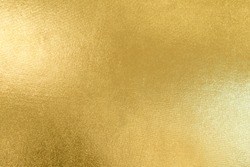 Gold texture background with yellow luxury shiny shine glitter sparkle of bright light reflection on golden surface, for celebration backdrop, wallpaper, Christmas decoration background or any design