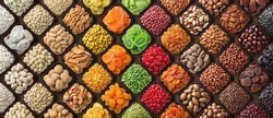 colorful dried fruits, assorted nuts and seeds background. mixed raw food for snacking, top view.