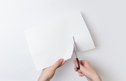 two hands cutting paper